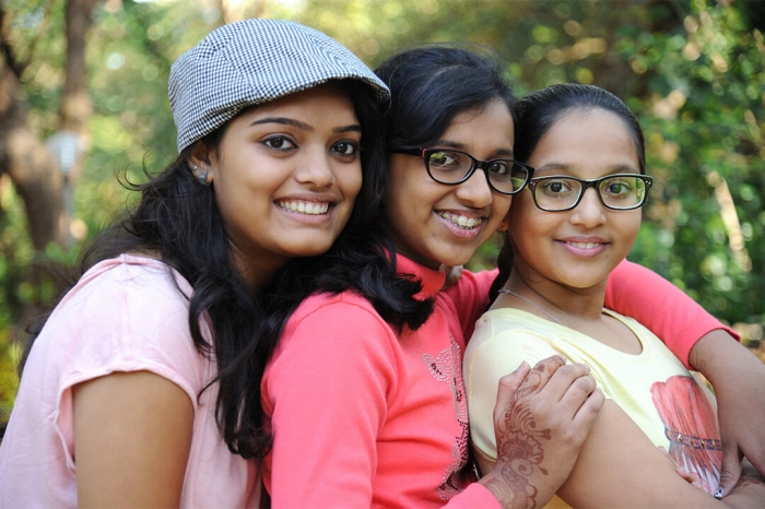Group of 3 girls smiling towards camera
